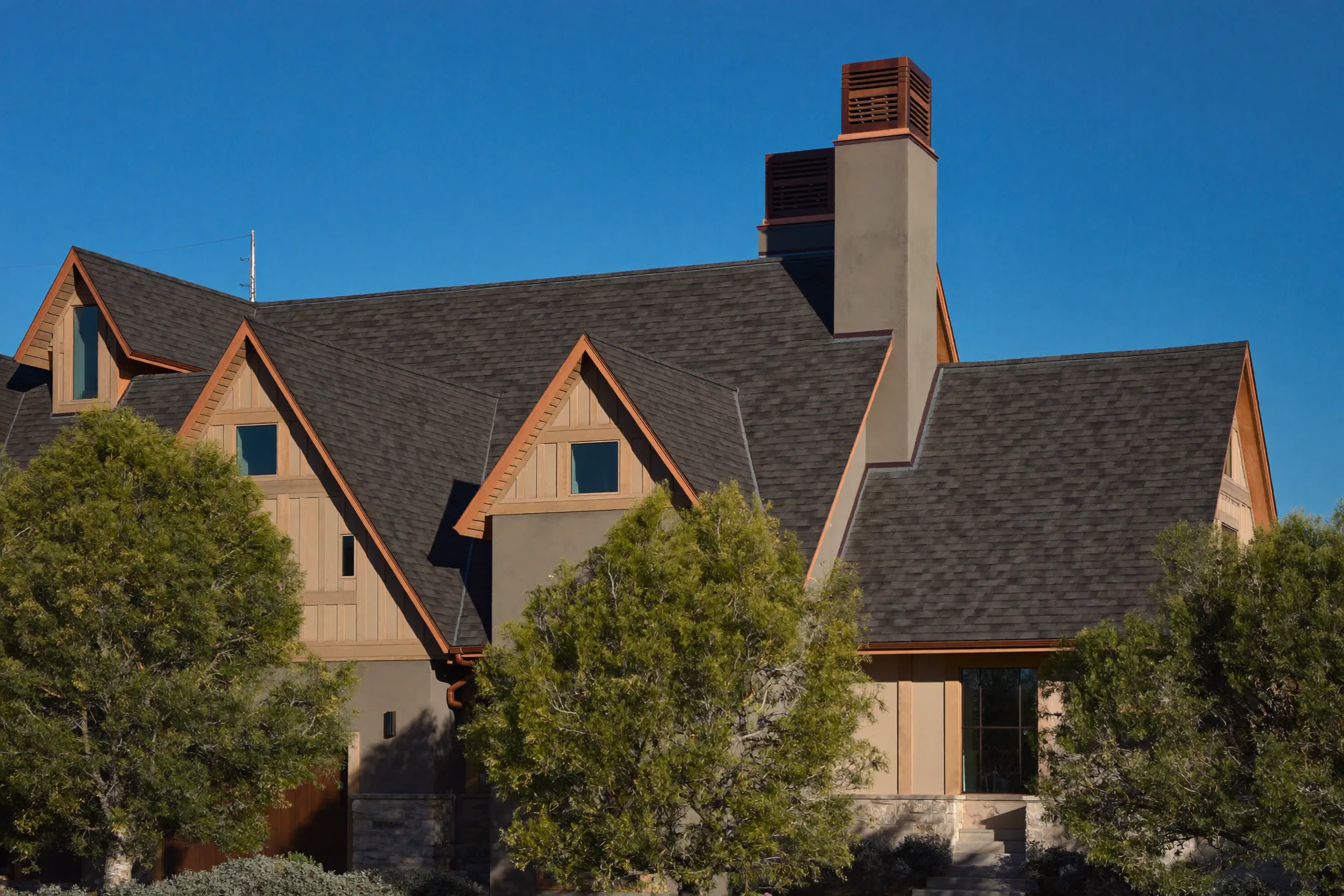 Slate-look designer shingle roof with copper flashing on a Highland Park estate