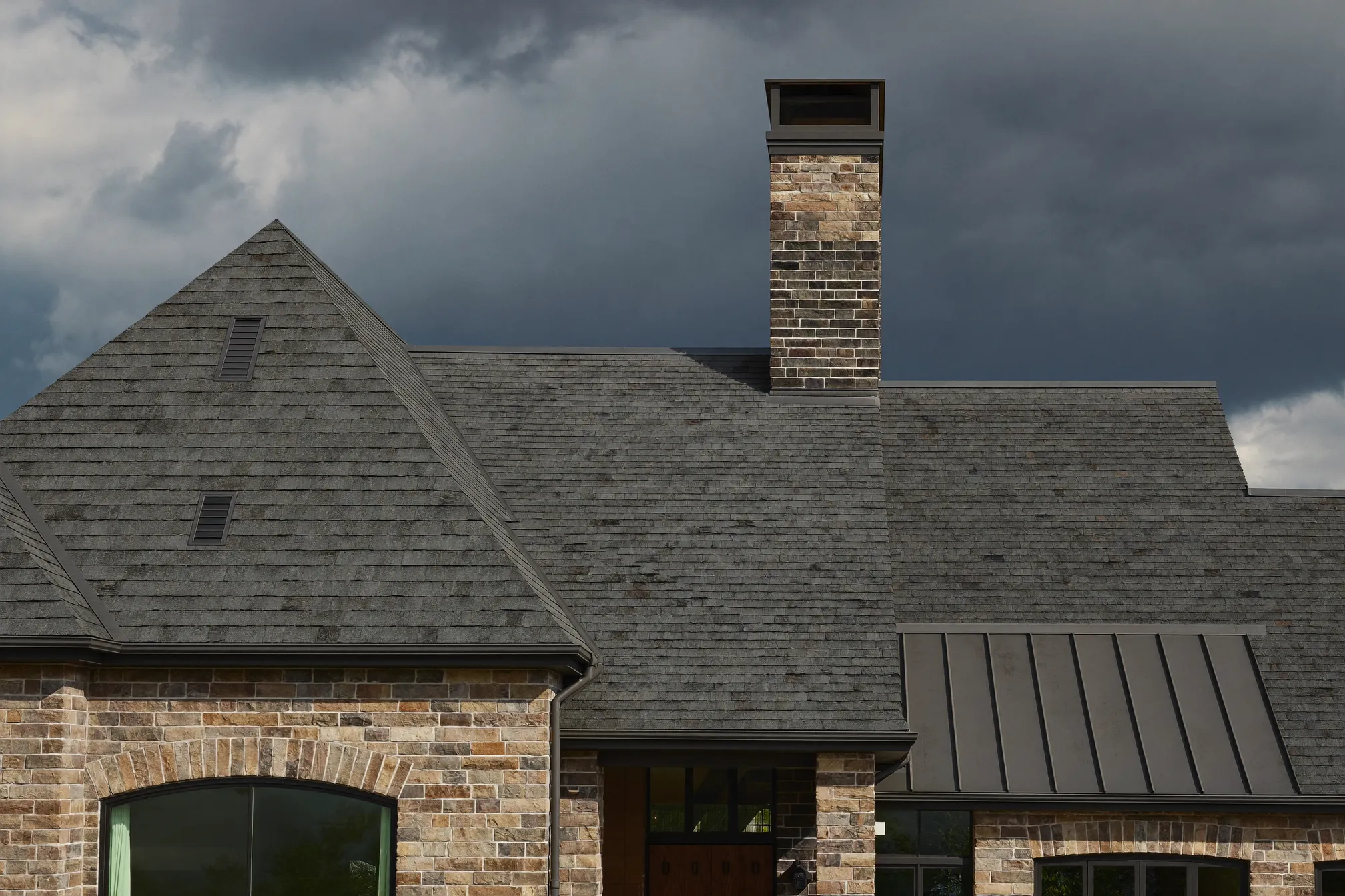 New architectural shingle roof on a Prosper home under a dark storm sky